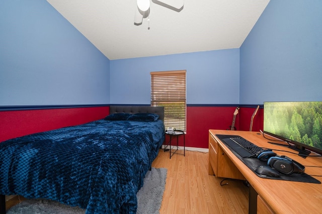 bedroom with vaulted ceiling, ceiling fan, wood finished floors, and baseboards