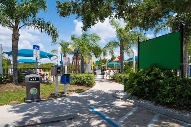 view of road with traffic signs and a gated entry