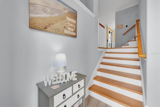 stairs featuring wood finished floors