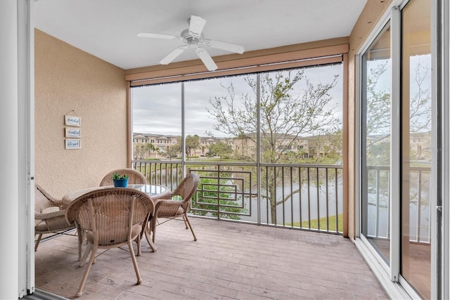 sunroom / solarium with a ceiling fan