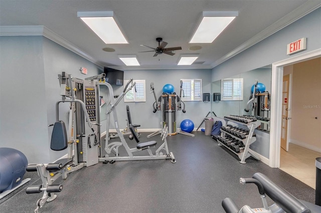 gym featuring a ceiling fan, crown molding, and baseboards