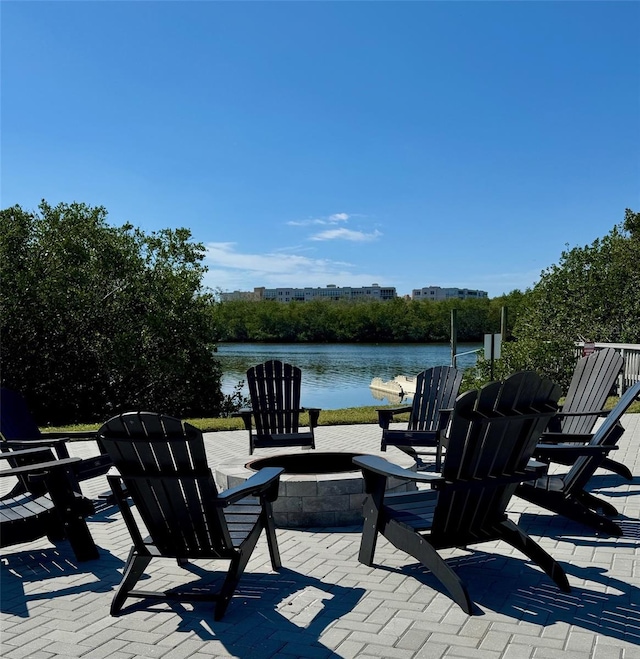 view of patio / terrace with a water view and an outdoor fire pit