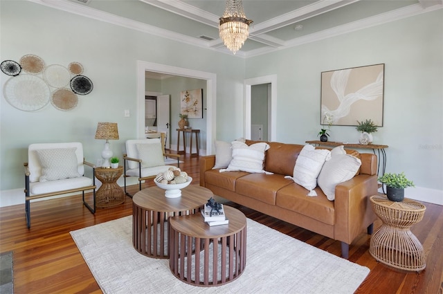 living area featuring visible vents, ornamental molding, wood finished floors, a notable chandelier, and coffered ceiling