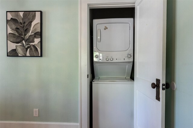 laundry room featuring laundry area and stacked washer and clothes dryer