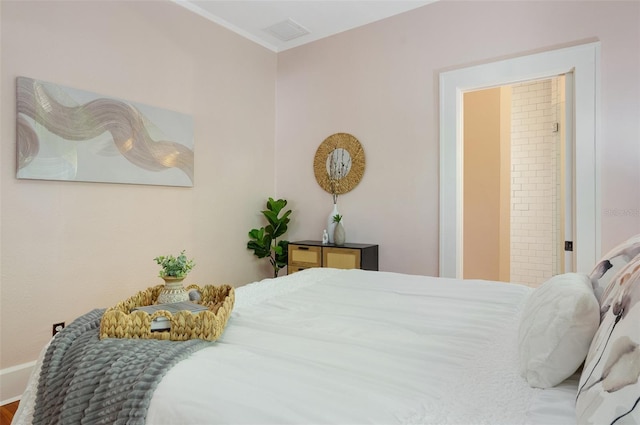 bedroom with crown molding and visible vents