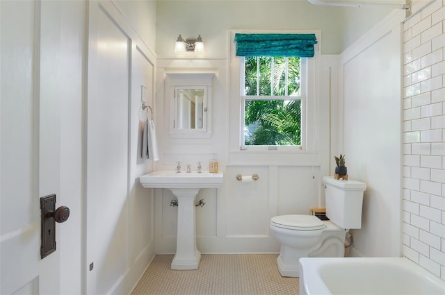 full bathroom with tile patterned floors, toilet, and a bathtub