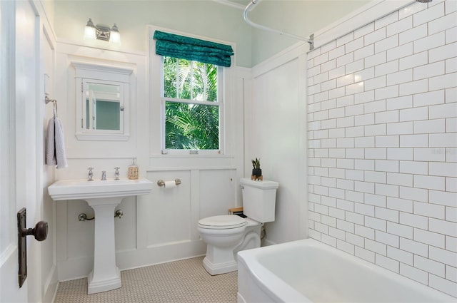 full bathroom with toilet,  shower combination, and tile patterned flooring