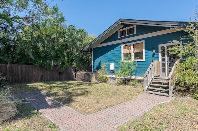 view of front of home featuring a front lawn and fence