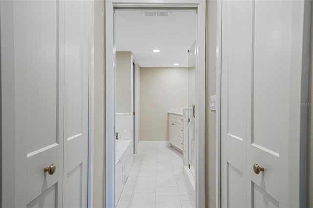 corridor with visible vents, light tile patterned floors, recessed lighting, and baseboards