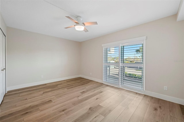 empty room with light wood-style flooring, baseboards, and ceiling fan