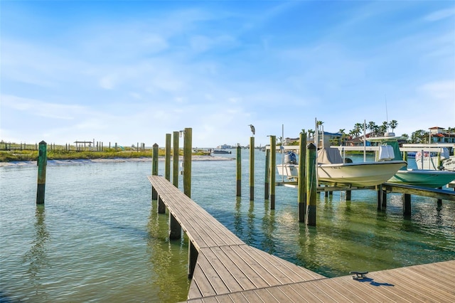 dock area featuring boat lift and a water view