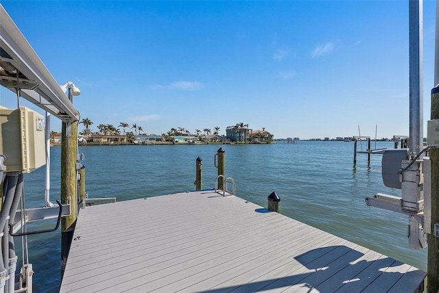 dock area with a water view and boat lift