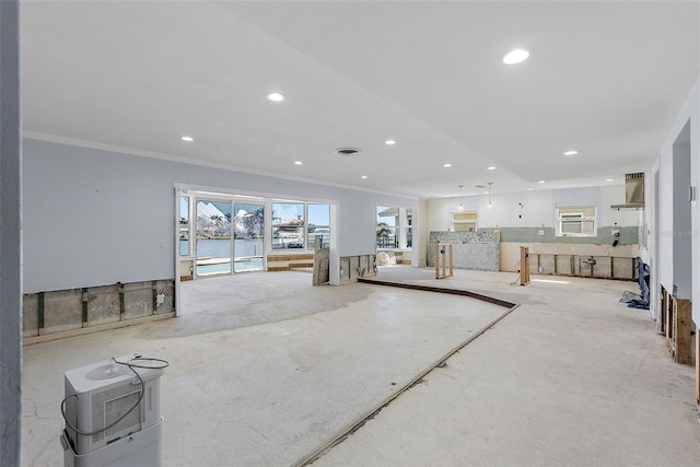 living room with ornamental molding and recessed lighting