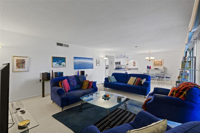 living area featuring baseboards, visible vents, light colored carpet, a textured ceiling, and a notable chandelier