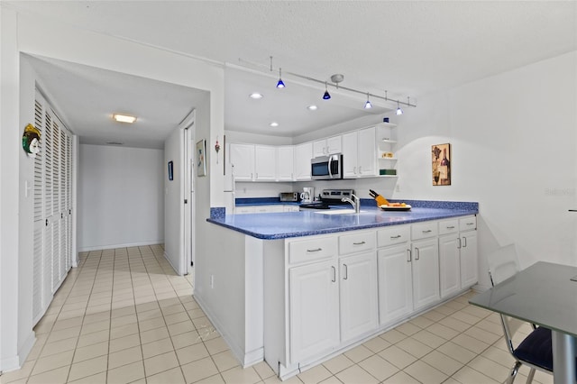 kitchen featuring open shelves, stainless steel appliances, dark countertops, white cabinets, and light tile patterned flooring