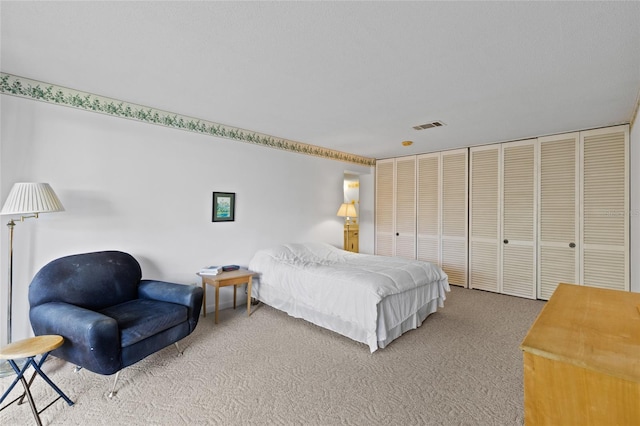 carpeted bedroom with visible vents