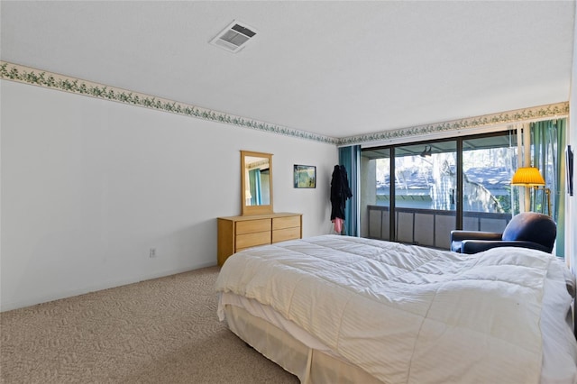 carpeted bedroom featuring visible vents and baseboards