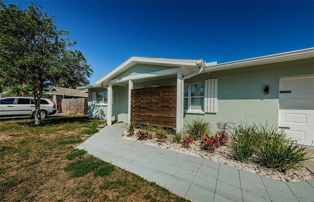 exterior space with a garage and a lawn