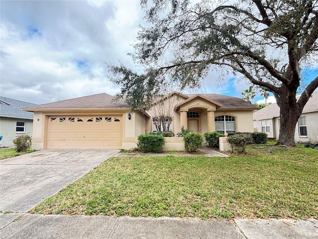 ranch-style house with a garage, a front yard, concrete driveway, and stucco siding