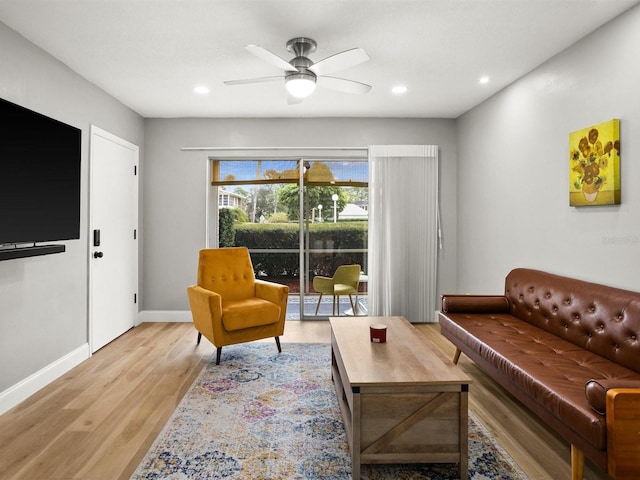 living room featuring light wood finished floors, baseboards, a ceiling fan, and recessed lighting