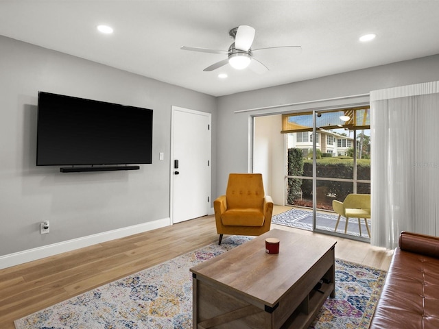 living room featuring a ceiling fan, recessed lighting, baseboards, and wood finished floors