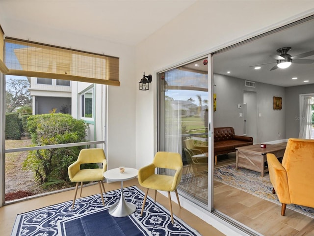 sunroom featuring ceiling fan and visible vents