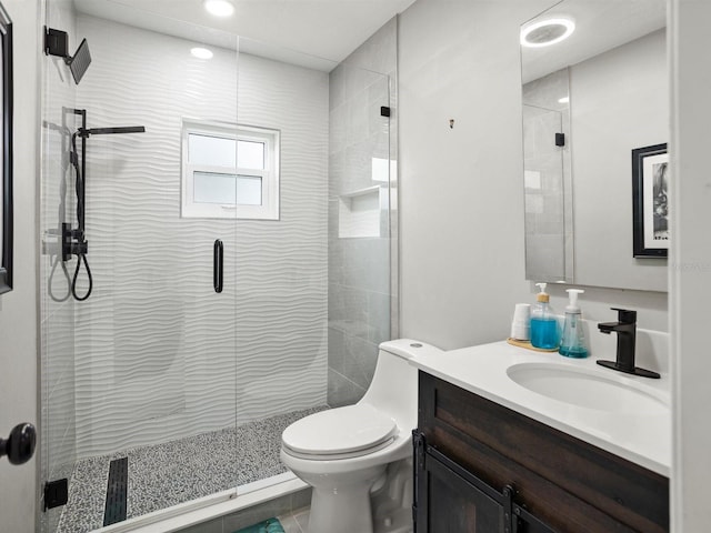 full bathroom with vanity, toilet, and a shower stall