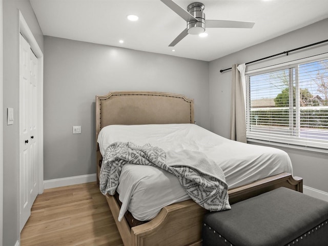 bedroom featuring ceiling fan, light wood-style flooring, recessed lighting, baseboards, and a closet