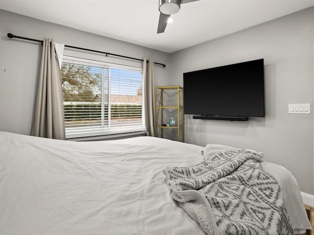 bedroom featuring baseboards and a ceiling fan