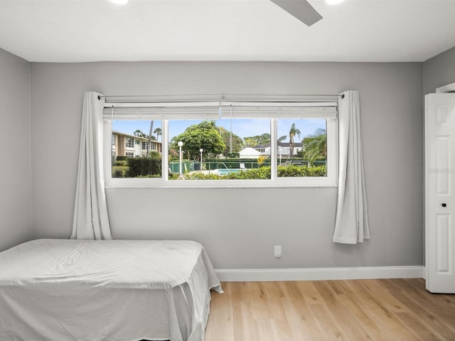 bedroom with light wood-style flooring and baseboards