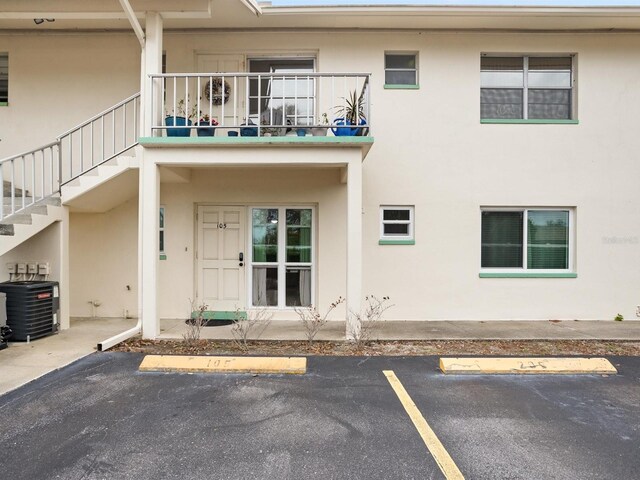 exterior space with uncovered parking and stucco siding