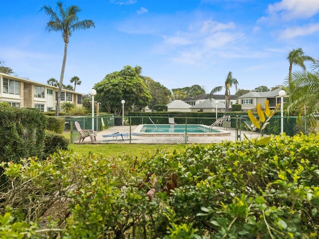 view of pool with a pool and fence