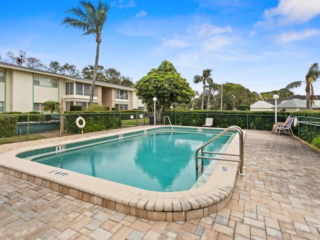 pool featuring a patio area and fence