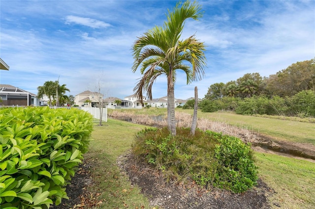 view of yard featuring fence and a residential view