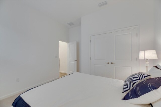 bedroom with a closet and baseboards