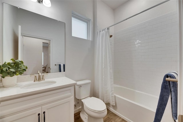 full bath with wood finished floors, vanity, toilet, and shower / bath combo with shower curtain