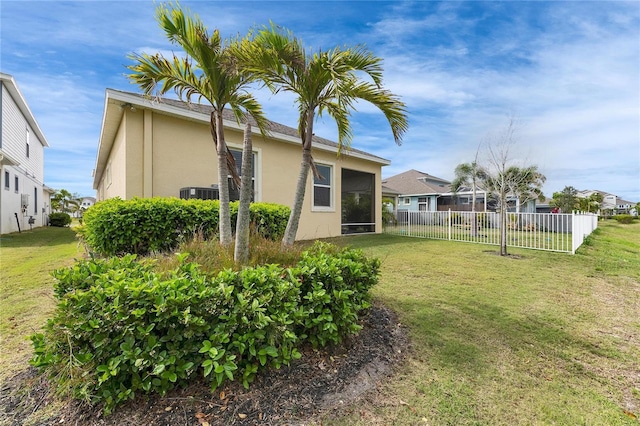 view of yard featuring a sunroom and fence