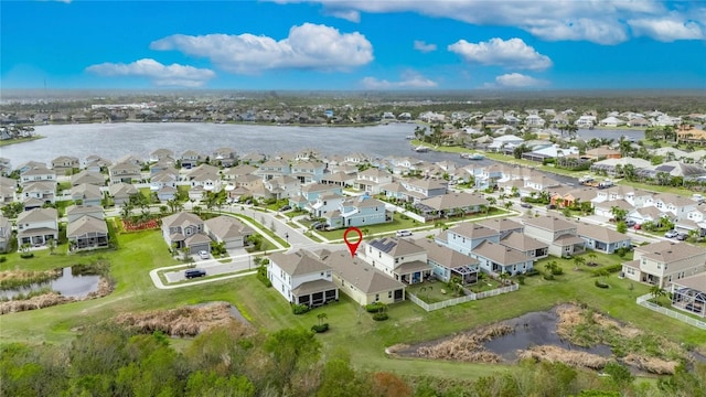 drone / aerial view with a water view and a residential view