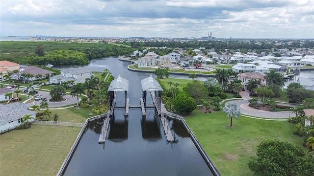 birds eye view of property featuring a water view and a residential view