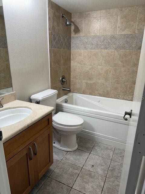 full bathroom featuring toilet, tile patterned floors, vanity, and shower / bathing tub combination