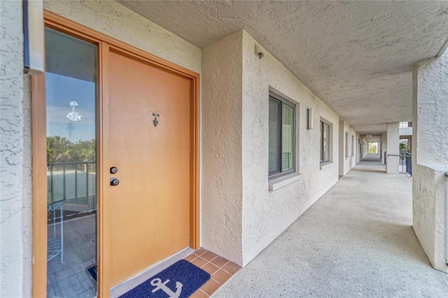 entrance to property featuring stucco siding