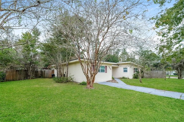 ranch-style home with driveway, a front yard, and fence