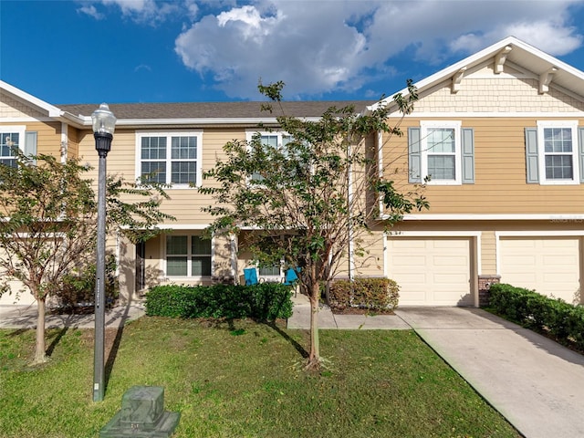 multi unit property featuring an attached garage, driveway, and a front yard