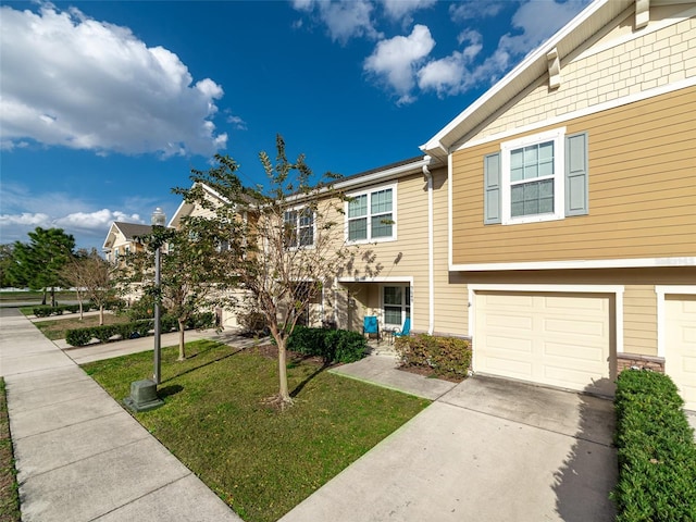 multi unit property featuring concrete driveway, an attached garage, and a front lawn