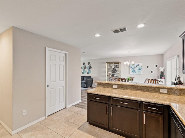 kitchen with light tile patterned floors, visible vents, a peninsula, an inviting chandelier, and dark brown cabinets