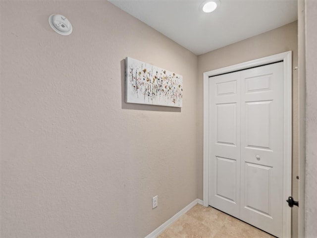 interior space with baseboards and a closet