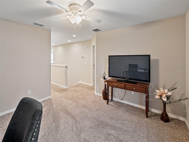 living area featuring a ceiling fan, carpet, visible vents, and baseboards