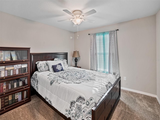 bedroom with a ceiling fan, carpet flooring, and baseboards