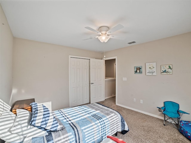 carpeted bedroom with ceiling fan, a closet, visible vents, and baseboards