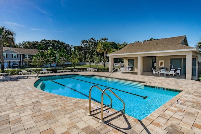 pool featuring a patio area and fence